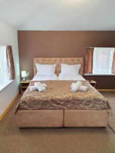 a bedroom with a large bed with two pillows at Guest House Gurkov in Veliko Tŭrnovo