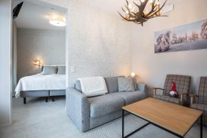 a living room with a couch and a bed at Santa Claus Holiday Village in Rovaniemi