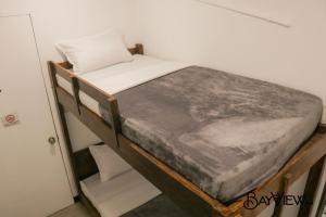 A bed or beds in a room at Bay View Inn