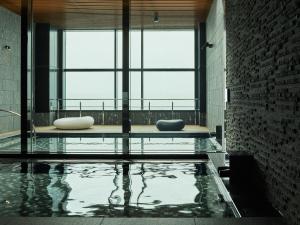 a pool of water in a room with windows at Mitsui Garden Hotel Toyosu Premier - Tokyo in Tokyo