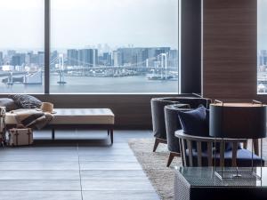 
a living room filled with furniture and a large window at Mitsui Garden Hotel Toyosu BAYSIDE CROSS Tokyo in Tokyo
