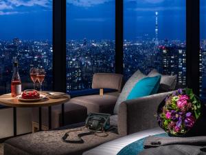 a room with a view of a city at night at Mitsui Garden Hotel Toyosu Premier - Tokyo in Tokyo +52 photos
