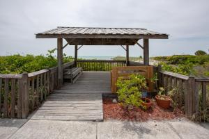 a wooden boardwalk with a gazebo and some plants at Venice Villas * Studio #60 in Venice