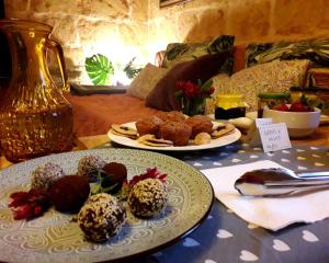 a table with two plates of food on it at Laremi Gozo B&B in Nadur