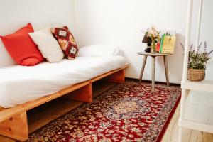 a room with a bench with pillows and a rug at רוח מדבר - Desert wind in Dimona