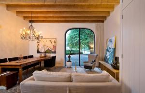 a living room with a couch and a table at Villa Polder - Boutique Hotel near Eindhoven in Gemert