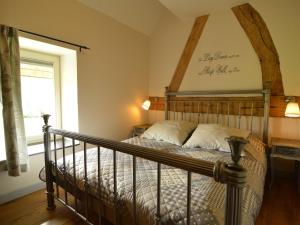 a bedroom with a bed with a wooden headboard at Holiday Home in Slenaken near Forest in Slenaken