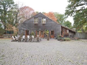 een huis met stoelen en tafels ervoor bij Holiday Home in Wellerlooi with Private Garden in Wellerlooi