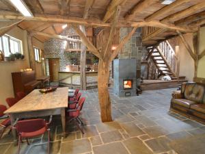 a living room with a table and a fireplace at Holiday Home in Wellerlooi with Private Garden in Wellerlooi