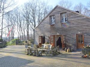 a barn with a table and chairs in front of it at Holiday Home in Wellerlooi with Private Garden in Wellerlooi