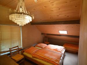 a bedroom with a bed and a chandelier at Holiday Home in Wellerlooi with Private Garden in Wellerlooi