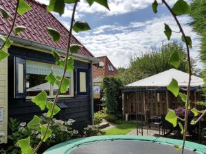a view of the garden from the house at Holiday Home in t Zand close to the Dutch coast in 't Zand