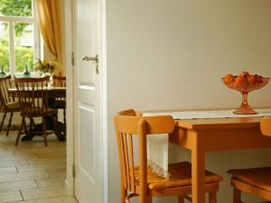 a dining room with a wooden table and chairs at Farmstay with Garden Views in Stokhem