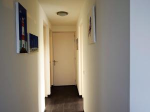a hallway with white walls and a white door at Bright Holiday Home in Noordwijk near Sea in Noordwijk