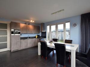 a kitchen and dining room with a table and chairs at Bright Holiday Home in Noordwijk near Sea in Noordwijk