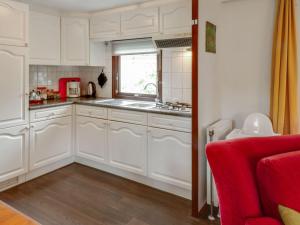 A kitchen or kitchenette at Tasteful chalet near Ommen for family