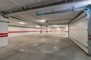 an empty garage with white walls and red accents at Modern and Stylish Apartment w Terrace in Cluj-Napoca