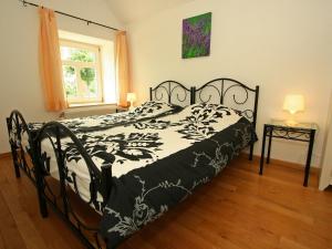 a black and white bed in a room with a window at Restored farmhouse in Wijlre with two terraces in Wijlre