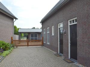 a brick building with a door and a patio at Luxury apartment in Posterholt with a terrace in Posterholt