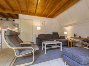 a living room with a couch and a table at Comfortable holiday home in Nunspeet in Nunspeet