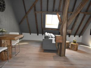 a living room with a couch and a window at Apartment Hazenborgh near the coast in Callantsoog in Callantsoog