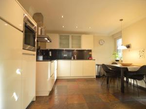 a kitchen with a table and a dining room at Stunning villa in Venhorst with sauna in Venhorst