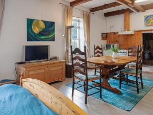 a living room with a table and a tv at Characteristic head neckhull farm with rowing boat in Burum