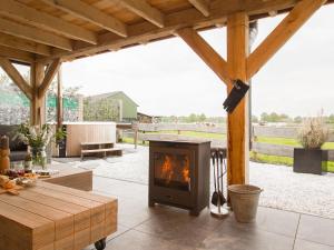 a fireplace in the middle of a patio at Beautiful holiday farm in Holten in Holten