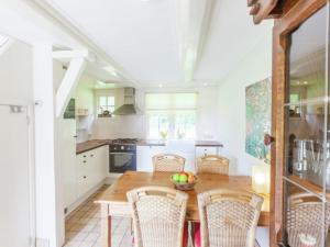 a kitchen with a wooden table and chairs at Cozy Holiday Home near Forest in Baarn in Baarn