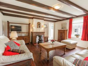 a living room with a couch and a fireplace at Cozy Holiday Home near Forest in Baarn in Baarn