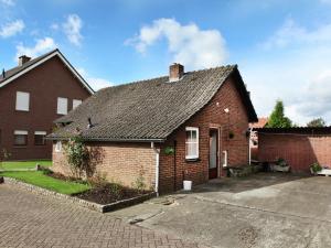 a red brick house with a driveway at Tranquil Holiday Home in Margraten in Margraten