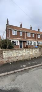 a brick house on the side of a street at Hartendale in Flamborough