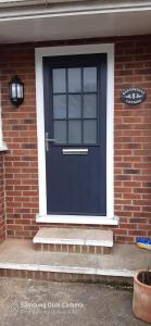 a blue front door of a brick house at Hartendale in Flamborough