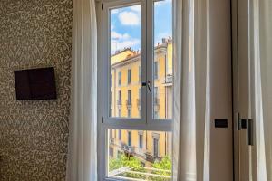 ventana con vistas a un edificio en Aiello Rooms, en Milán