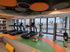 a gym with treadmills and ellipticals in a room at Grand Residence by NewInn in Basaksehir