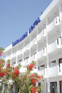 a large white building with a blue sky at Mariandy Hotel in Larnaca