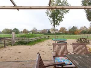 a picnic table with two chairs and a playground at Elegant Holiday Home with Horssen with Terrace in Horssen