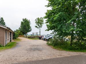 a gravel road with parked cars and a playground at Elegant Holiday Home with Horssen with Terrace in Horssen
