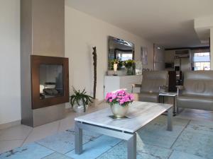 a living room with a vase of flowers on a table at Sunny holiday home in Alkmaar on the water in Alkmaar