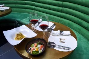 a table with a bowl of food and two glasses of wine at Magnolia Rooms in Naples