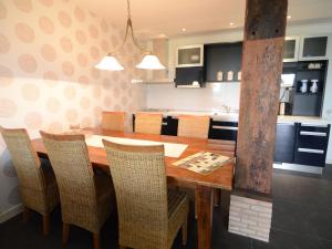 a kitchen with a wooden dining table and chairs at Rural holiday home with a lovely sunny terrace in Workum