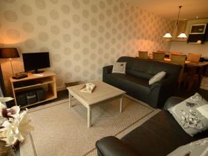 a living room with a couch and a table at Rural holiday home with a lovely sunny terrace in Workum