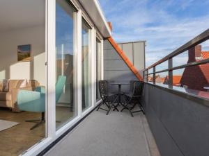 a balcony with a table and chairs on it at Apartment in Zoutelande near the Beach in Zoutelande