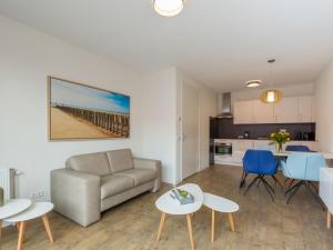 a living room with a couch and a table and chairs at Apartment in Zoutelande near the Beach in Zoutelande +32 photos