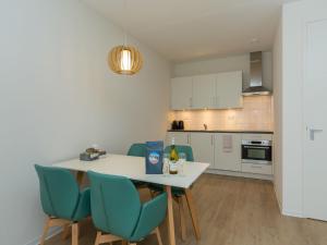 a kitchen with a table and chairs in a room at Apartment in Zoutelande near the Beach in Zoutelande