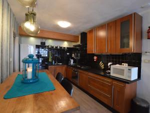 a kitchen with a wooden table and a microwave at Beautiful farmhouse in Wapse with fenced garden in Wapse