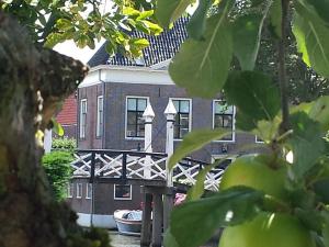 a building with a bridge in front of it at Lovely holiday home in Hindeloopen in Hindeloopen