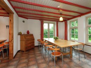 a dining room with a wooden table and chairs at Beautiful Holiday Home in Lage Mierde with Fireplace in Lage Mierde