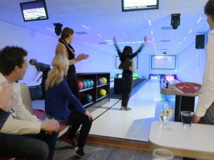 a group of people playing bowling in a bowling alley at Modern bungalow with nice garden at forest edge in Rijssen