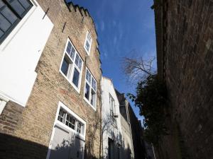 a tall brick building with white windows on a street at Boutique Holiday Home in Middelburg with Roof Terrace in Middelburg